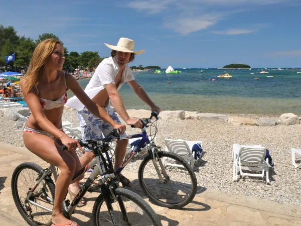 Cyclisme le long de la plage de galets du camping Roan Valkanela.