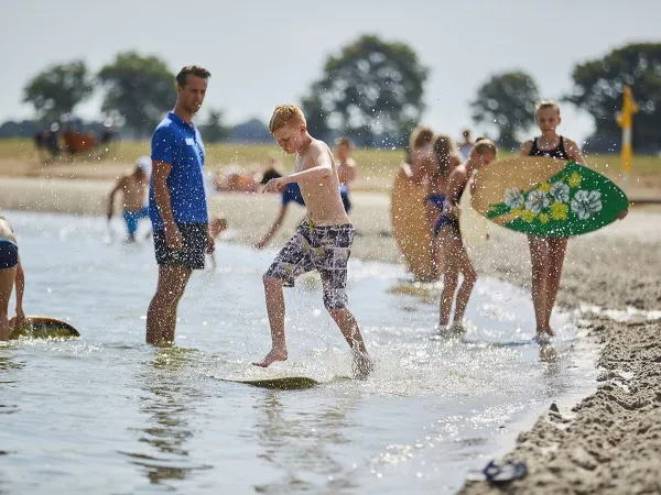 Planche à voile dans l'étang du camping Roan Terspegelt.