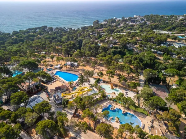 Aperçu des piscines et de l'environnement verdoyant du camping Roan Internacional de Calonge.