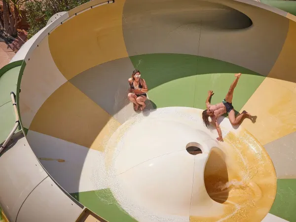 Deux personnes s'amusent sur le toboggan tornade du camping de Roan Le Petit Mousse.